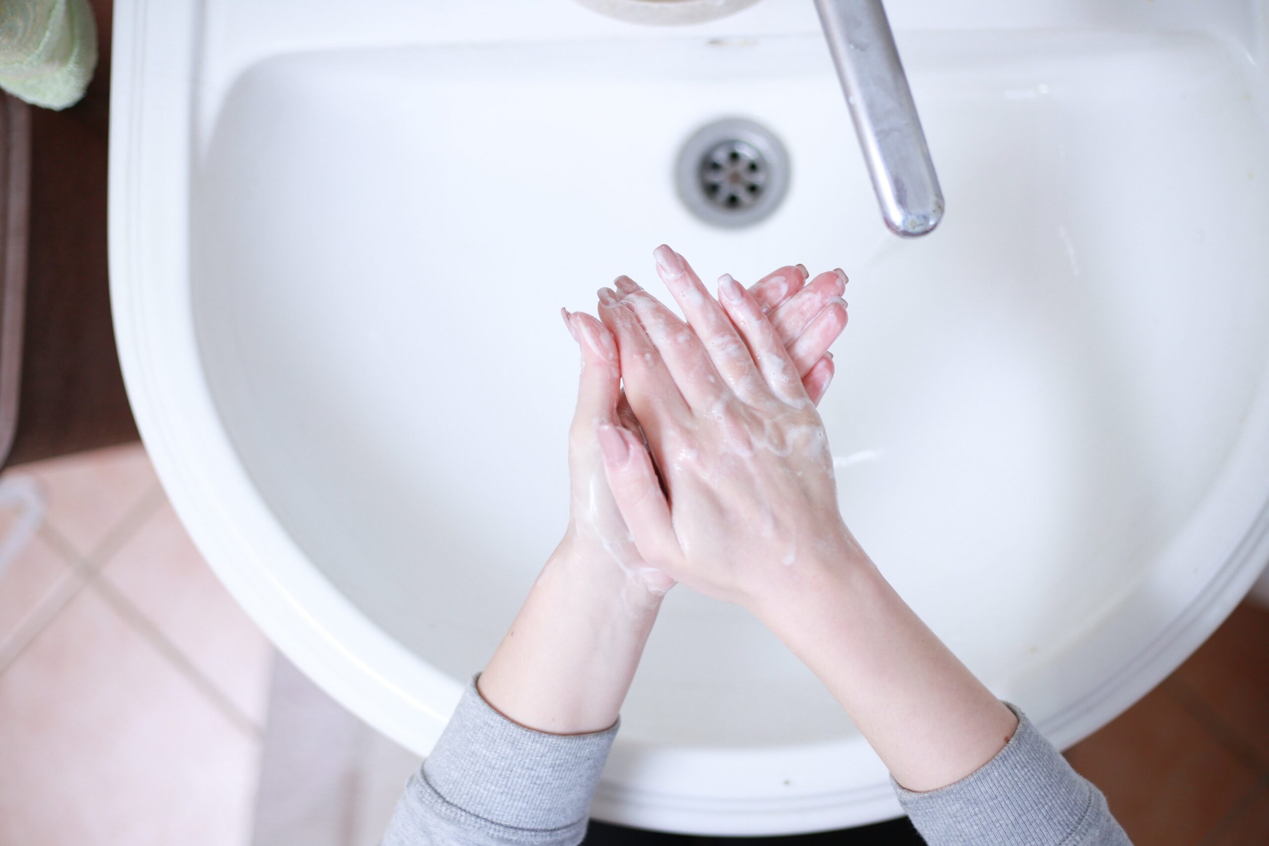 Hands being washed for hygiene, background image for whether nail fungus is contagious